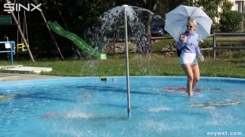 Playful Blonde Gets Drenched Under Water Fountain Screencap 3 on sinx.preview.netperv.com